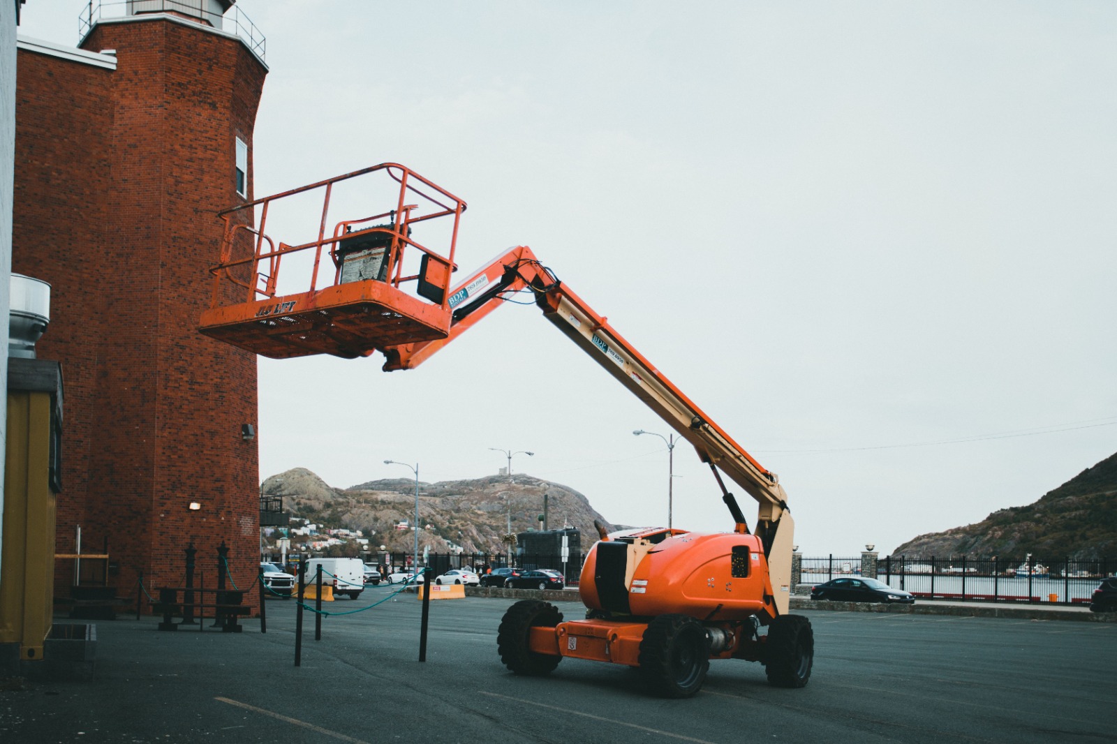 Electric scissor lift in Fujairah positioned at a construction site for elevated maintenance work