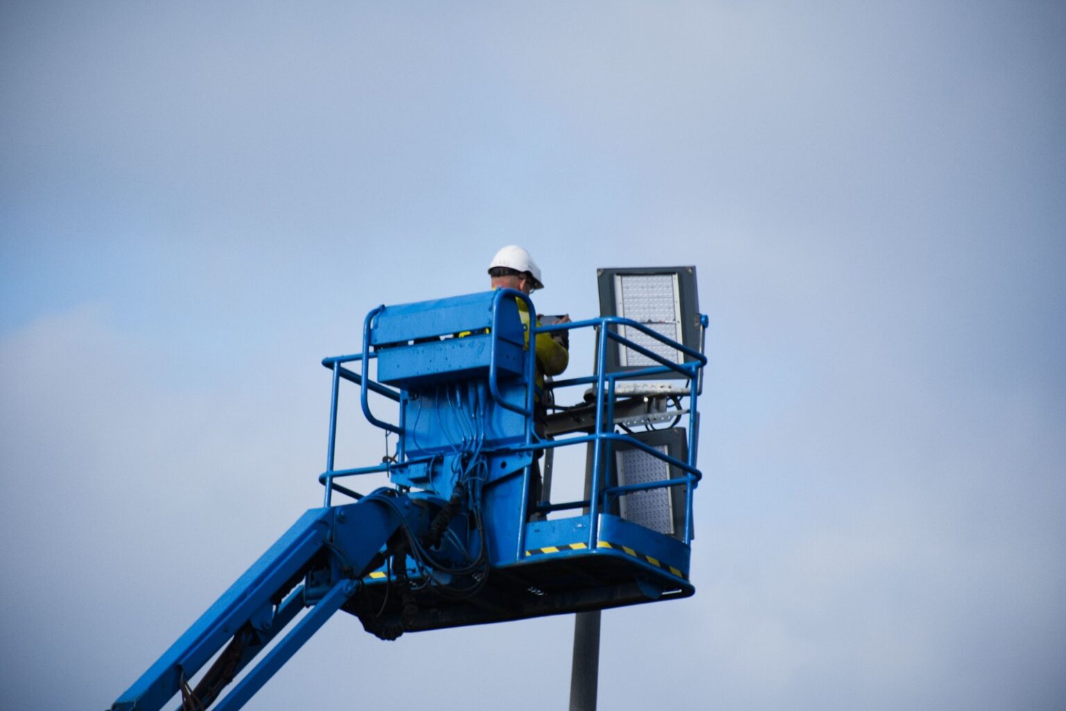 Electric scissor lift in Sharjah positioned on a construction site ready for rental or sale by Zoomlift.