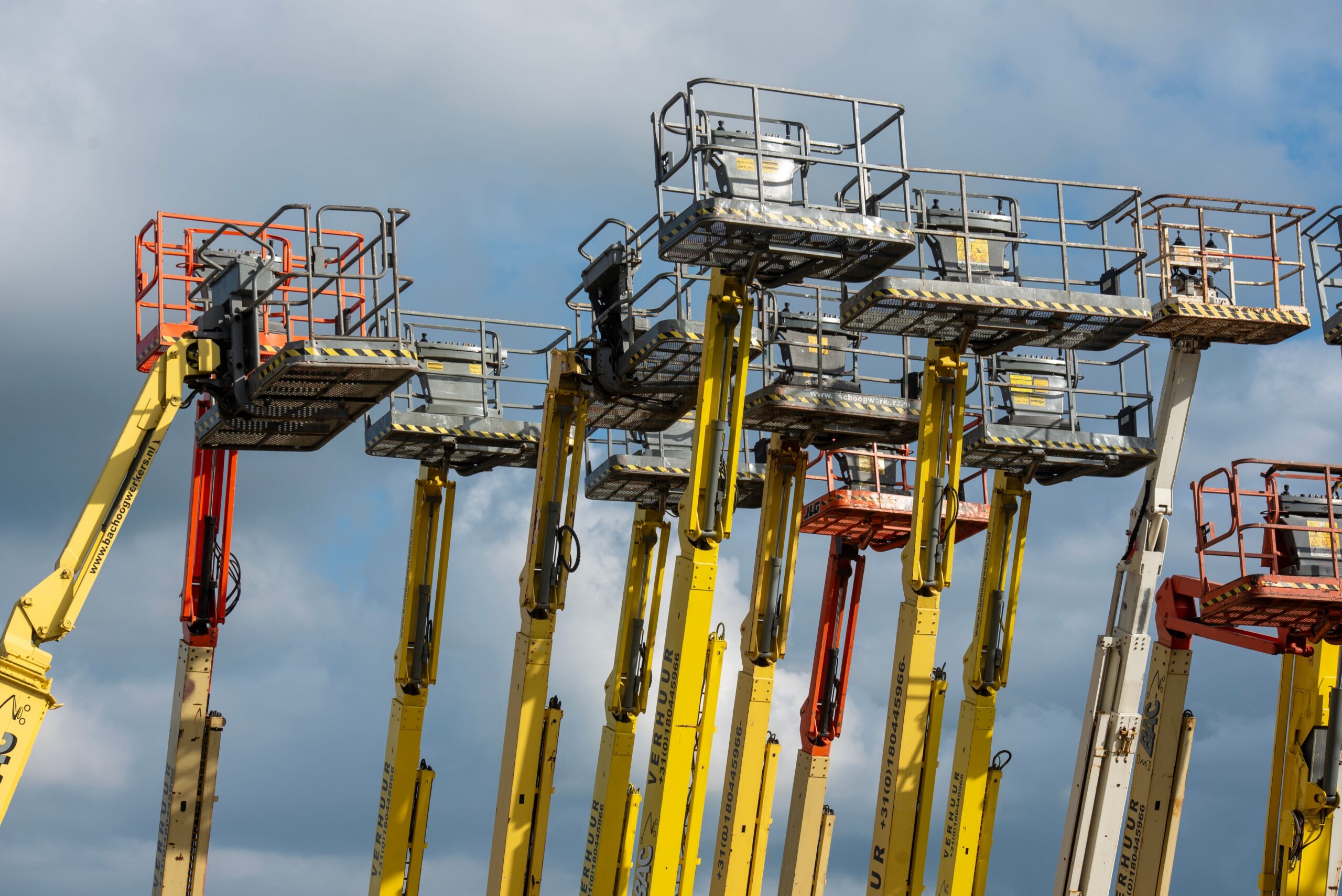 Electric scissor lift in Dubai positioned on a construction site ready for warehouse and indoor maintenance work.