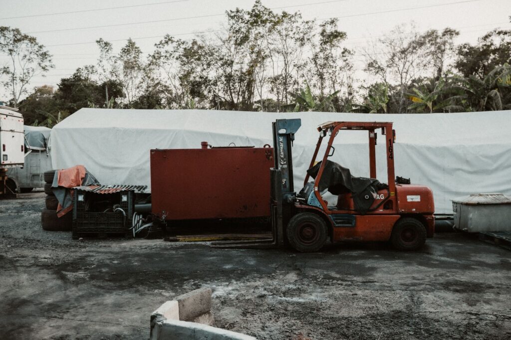 Electric forklift in Dubai warehouse lifting pallets for a logistics company operation.