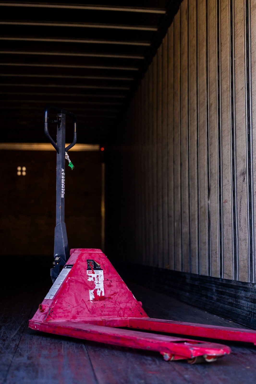 Electric pallet truck in Ajman used for daily warehouse handling and pallet transport tasks