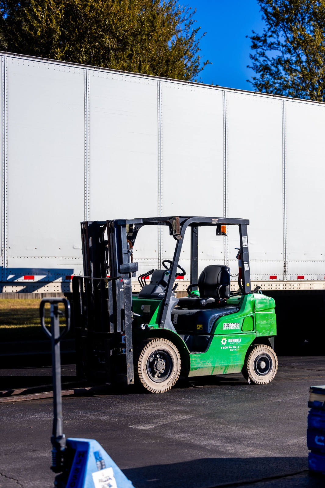 Electric pallet truck in Fujairah handling heavy loads at a port distribution facility.