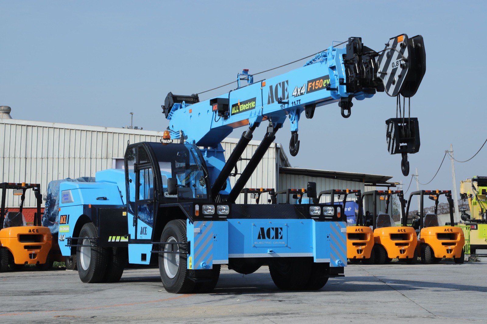 Compact Scissor Lift XE Mini Series passing through a narrow warehouse aisle during a Dubai facilities project.