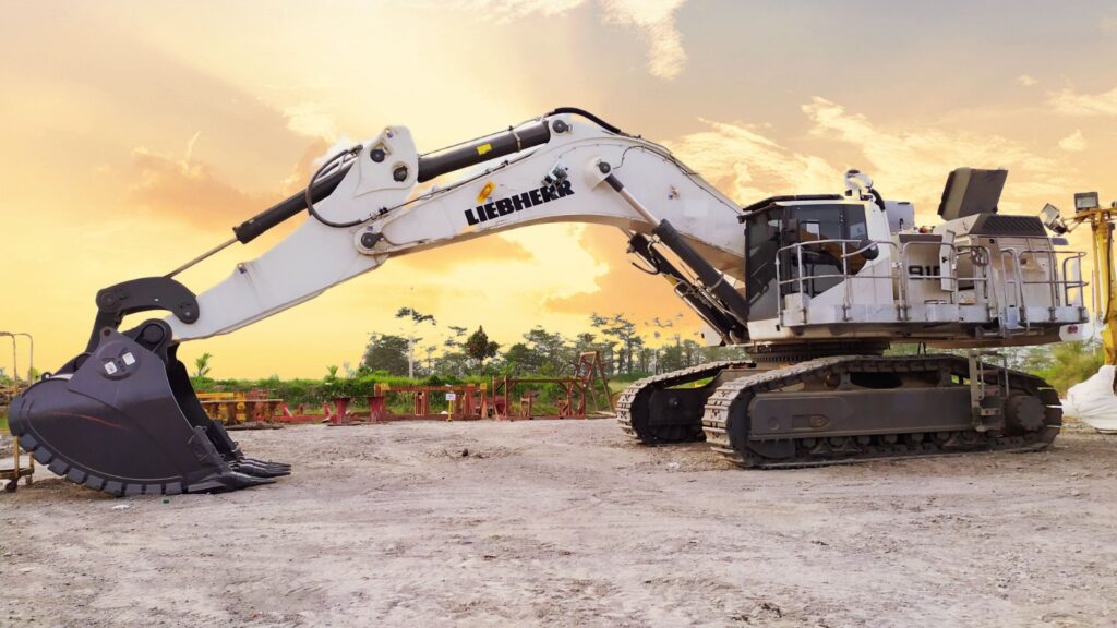 Technician inspecting a used crawler excavator in Abu Dhabi before sale to ensure quality and reliability.