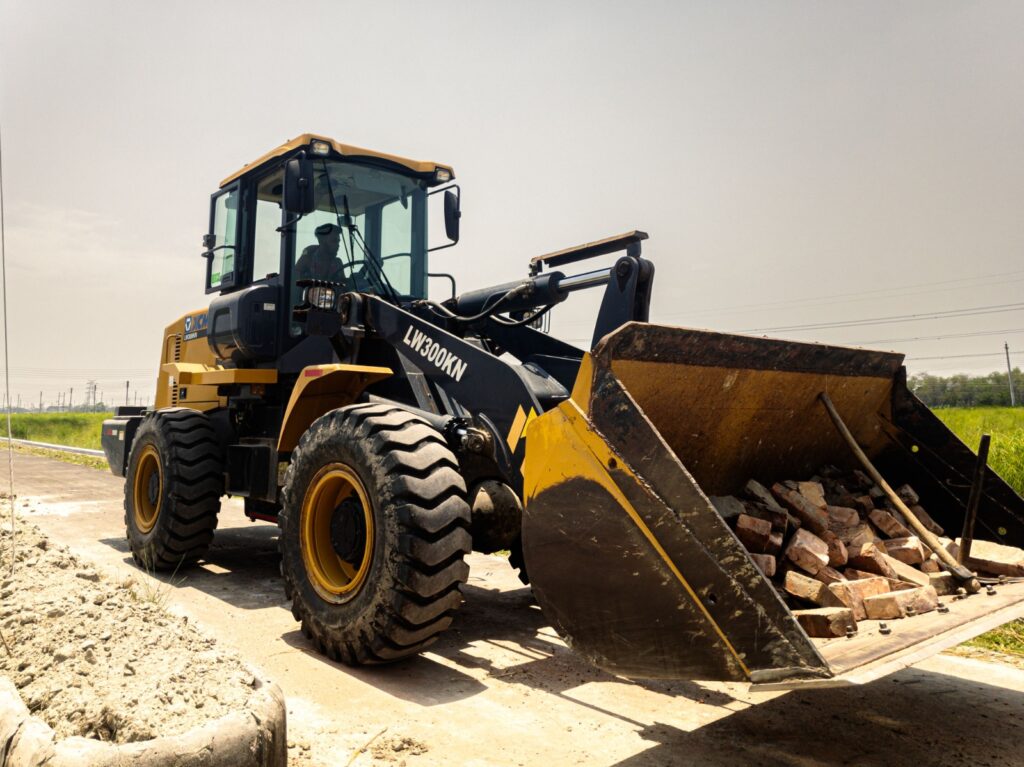 Used wheel loader operating on an Abu Dhabi construction site, showing bucket loading material capacity