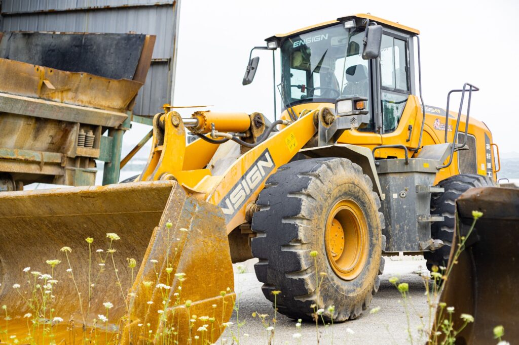 Wheel loaders in Abu Dhabi lined up at a Zoomlift equipment yard ready for sale and delivery.